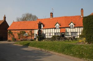 Timber framed public house and garden.